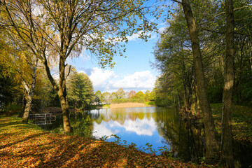 Ostheim natural bathing lake near Malsfeld. Idyllic landscape by the lake in autumn. 
