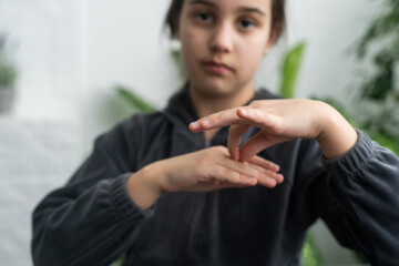 A smiley teenage girl hand sign