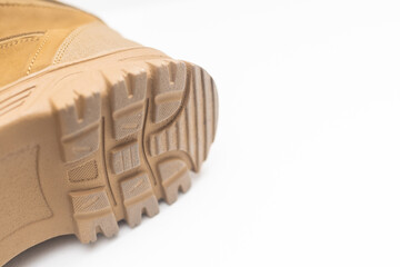 Khaki high military boots on a gray background