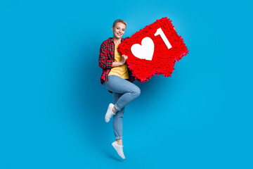 Full body length photo of positive blonde short hairstyle woman hold red pinata like symbol popular...