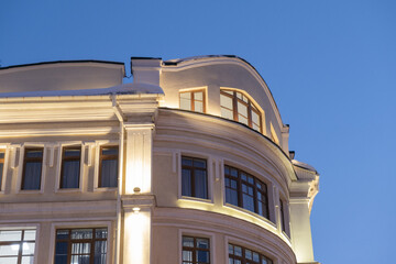 Corner of a modern building in classical style in the evening