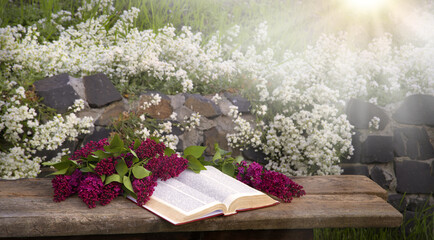 Still life from ancient book and lush boquet