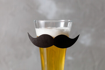 Glass with beer and mustache. Movember. Concept of father's day, bachelor party, february 23
