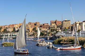 Felucca Sailing on the Nile River in Aswan. Popular Tourist Sailboat in the Nile. Aswan, Egypt. Africa. 
