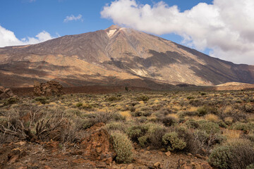 View of the Teide mountain. Pico de Teide with blue sky and clouds in the background. Tenerife, Spain, Europe. 