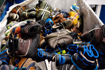 Brand new boots and shoes drives in large vinyl coated nylon box truck containers at donation center in Dallas, Texas, America