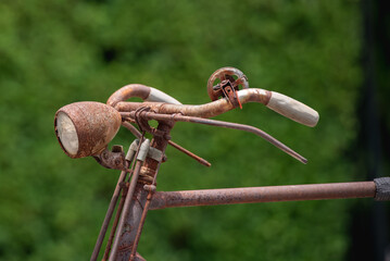 Old decay bicycle on green vine climbing garden wall outdoor. Rust Classic bike old bicycle on green garden wall retro style. Vine plant green leaves partition background.