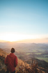 Naklejka premium Amazing moment at sunrise as a hiker celebrates his climb up the mountain and completing another point on the map. Trying to complete the journey. Ondrejnik, Beskydy mountains, Czech Republic