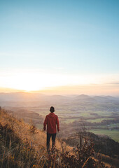 Obraz premium Amazing moment at sunrise as a hiker celebrates his climb up the mountain and completing another point on the map. Trying to complete the journey. Ondrejnik, Beskydy mountains, Czech Republic