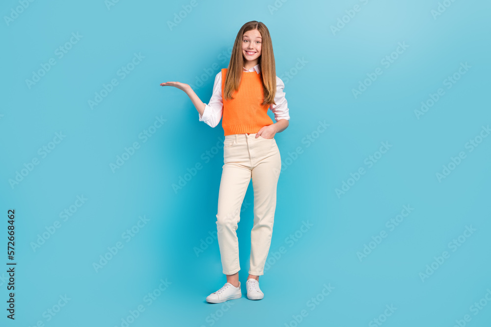 Sticker full length photo of positive cute lady dressed trendy clothes arm presenting empty space novelty is