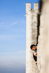 Multiracial couple posing on the walls of an old fortress. Man and woman in love.
