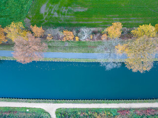 Fall colors around the canal Dessel Schoten aerial photo in Rijkevorsel, kempen, Belgium, showing the waterway in the natural green agricultural landscape. High quality photo. High quality photo
