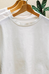 White cotton t-shirts on the hangers close-up