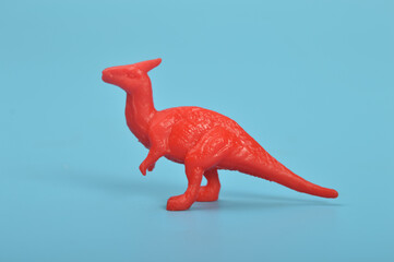 Parasaurolophus dinosaur toy model isolated on a blue background