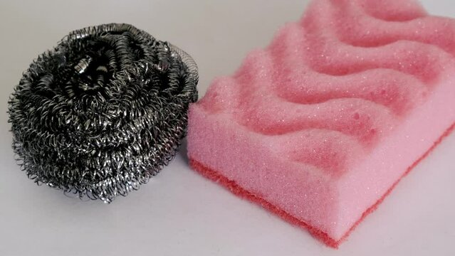 Demonstration of kitchen care products: kitchen and metal sponge on a white background. Up close
