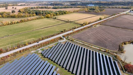 Solar panels on rural farmland in countryside generating sustainable energy and electric power for America homes and business