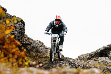 autumn downhill mountain biking. athlete rider riding on trail