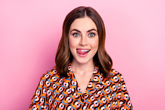 Photo portrait of lovely young lady lick teeth tasty food restaurant dressed stylish print garment isolated on pink color background