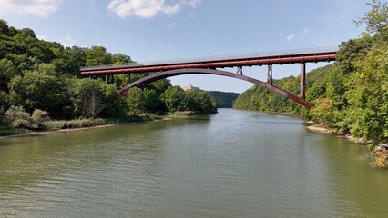 Fototapeta na wymiar Inner city walking, biking and hiking trail with bridge crossing peaceful river in Rochester NY Riverview Trail