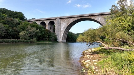 Fototapeta na wymiar Beautiful stone bridge with arches over river Veterans Memorial Bridge in Rochester New York 
