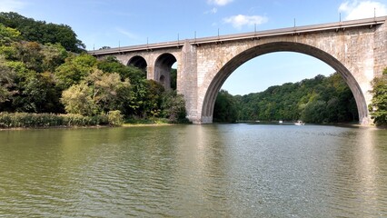 Fototapeta na wymiar Beautiful stone bridge with arches over river Veterans Memorial Bridge in Rochester New York 