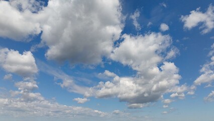 Beautiful puffy clouds in blue sky with sunshine