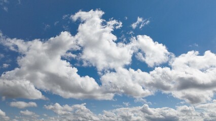 Beautiful puffy clouds in blue sky with sunshine