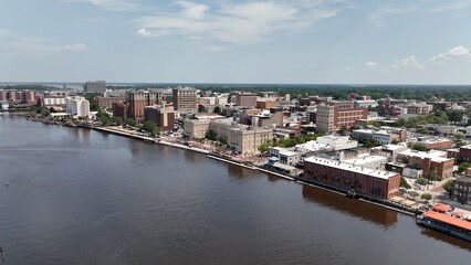 Wilmington, NC big city skyline beside water with office buildings with workers in inner city architecture
