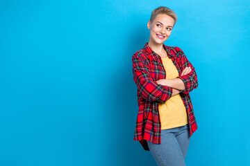 Photo of optimistic pretty girl with short hairstyle dressed red shirt arms folded look empty space...