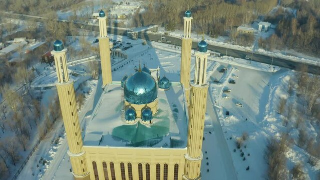 winter mosque in Ust Kamenogorsk drone view, evening sunset on the background of city