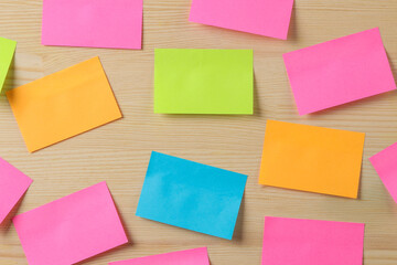 Multicolored different notes or sticky post-it on wooden office table background .mockup