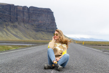 Road on Iceland, blond woman walking, amazing view, summer time