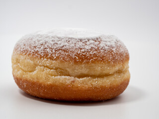 Freshly baked and dusted with powdered sugar German donuts. Donut berliner or krapfen on white background.