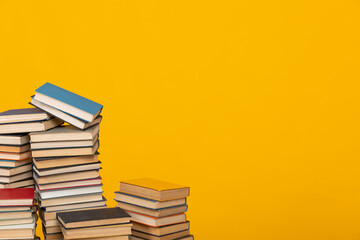 many books stacked in the library on a yellow background science knowledge reading