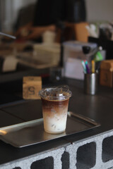 Closeup of Iced Caramel Macchiato at the coffee shop, Caramel Macchiato is a classic macchiato beverage. It consists of vanilla syrup, espresso, steamed milk, foam, and caramel drizzle