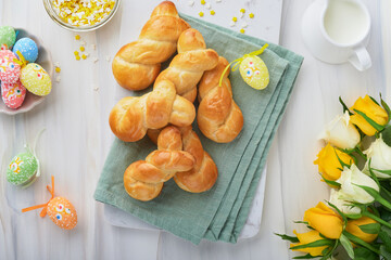 Easter breakfast Holliday concept. Easter bunny buns rolls with cinnamon made from yeast dough with...