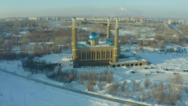 winter mosque in Ust Kamenogorsk drone view, evening sunset on the background of city