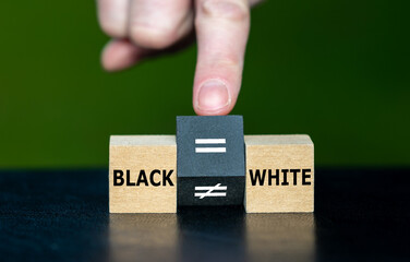 Symbol for equal rights of persons with different skin colors. Hand turns wooden cube and changes...