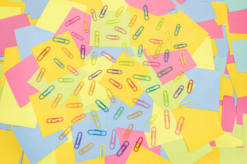 Obraz premium Multicolored paper clips on multicolored paper Sticky Notes