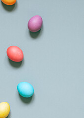 Colorful painted Easter eggs on the grey background. Top view. Copy space