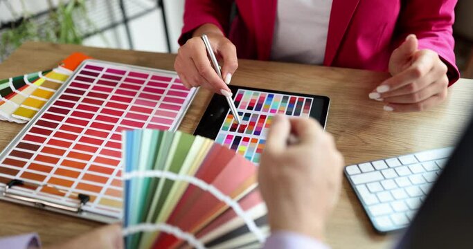 A woman designer in the office shows a color palette