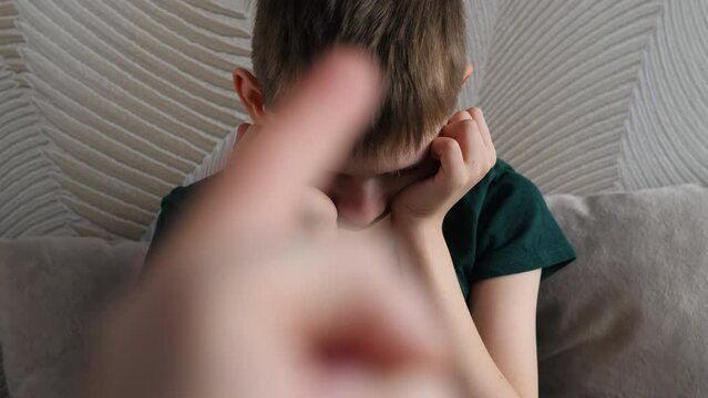 father punishes son swears waves hand gesticulating anger.selective focus, shallow depth of field. family violence concept.sad scared child afraid of parent's wrath