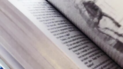 Going through the book pages, reading and education.