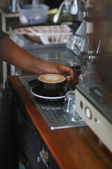 a cup of latte art in the coffee shop