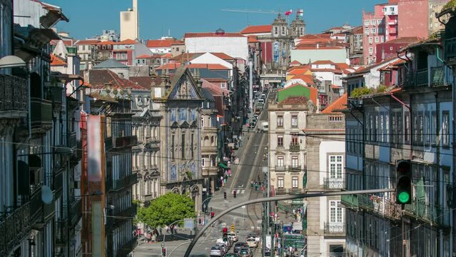 Aerial view of the Almeida Garret Square with the Sao Bento railway station and Congregados Church and Saint Ildefonso at the back timelapse, Porto, Portugal. Traffic on a busy street