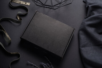 Black cardboard package box on dark background