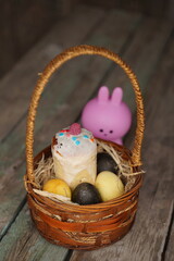 Rabbit with Easter eggs on wooden background. Selective focus.