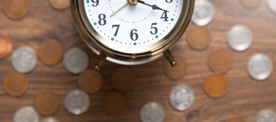 Fototapeta na wymiar Alarm clock and coins. Business