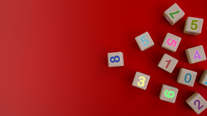 Colorful wooden cubes with numbers scattered on red background. learning, increasing IQ, development for children. Top view of children's toys. Educational games.