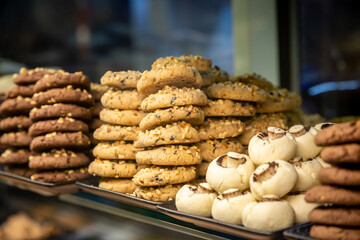 A bakery window display with piles of biscuits for sale